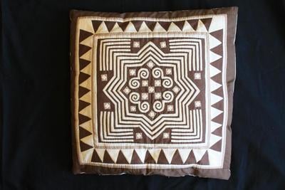 E1429: Hmong Pillow, Reverse Applique Brown and White, Snail and Star Motif.