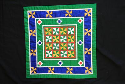 E1435: Hmong Pandau Reverse Applique, pinwheel motif