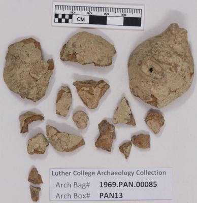 1969.PAN.00085: Broken whistle with sherds